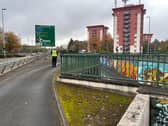 A West Midlands Police officer removes police tape from the scene