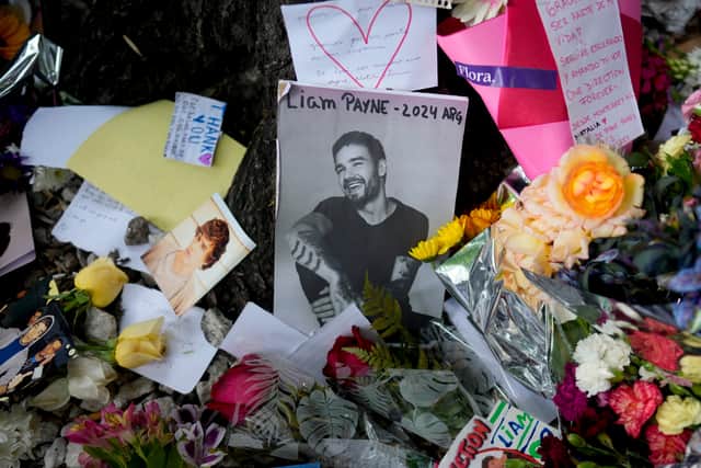 A picture of former One Direction singer Liam Payne is surrounded with flowers and candles as part of a makeshift memorial outside the hotel where he fell from a balcony to his death, in Buenos Aires, Argentina. Photo: Natacha Pisarenko/AP