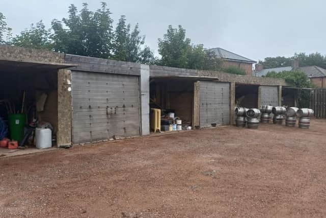 Before: the ugly concrete outbuildings....