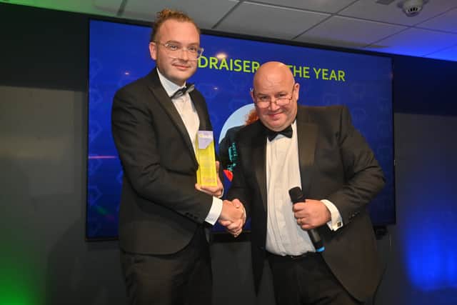 Alexander Goodger from Stourbridge Glass Museum receiving his award in 2025 from radio personality Dickie Dodd
