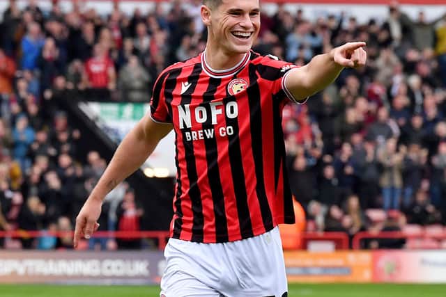 Evan Weir celebrates the opener against Tranmere, as he extended his season tally for Walsall to three with his first career brace in England.