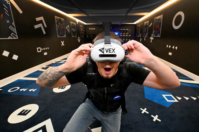 Fun City staff member Taylor Cole tries out a VR game