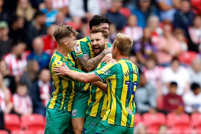 Nat Phillips is surrounded by his West Brom teammates after scoring against Stoke City