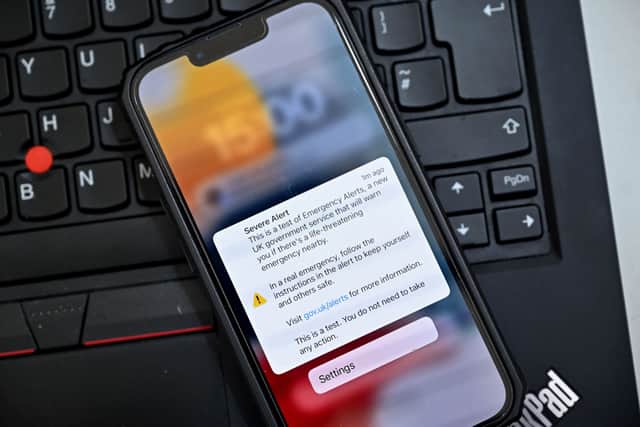 An emergency alert is shown on the screen of a smartphone in London on April 23, 2023, as the UK government tests a service meant to warn members of the public of a danger to life in their vicinity