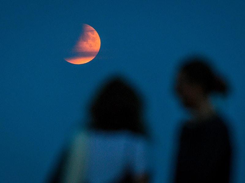 Partial lunar eclipse lights up skies 50 years on from Apollo 11 launch