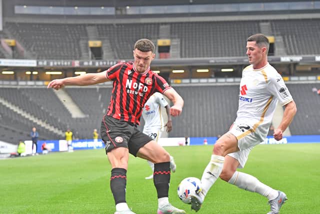 Jon Mellish blocks a cross from Walsall wing-back Connor Barrett.