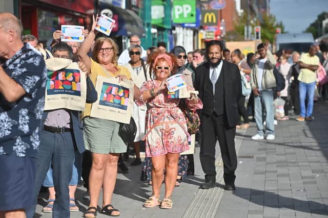 Dozens of people could be seen queueing outside to get into the market. Photo: Steve Leath
