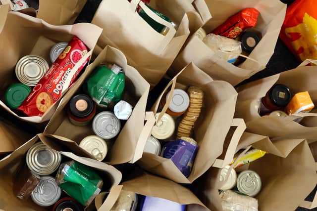 Food parcels were packed into paper bags to give out to families. Picture: Opus People Solutions