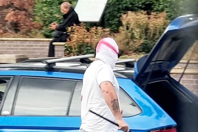 Two men wearing St George's masks have been captured on camera painting England flags on roundabouts and zebra crossings across a town.