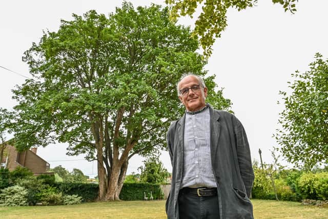Richard Gray pictured near the 250-year-old sycamore tree in Lower Brailes, Warwickshire which he is trying to save.