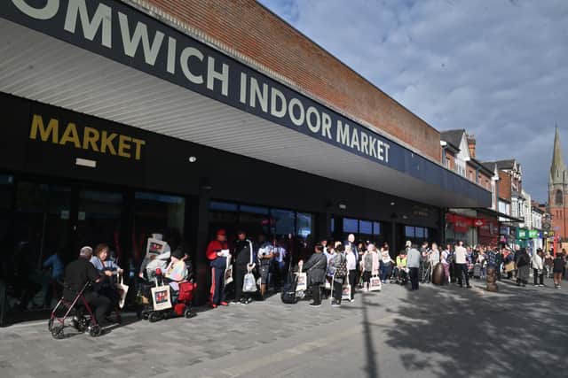There were long queues outside the market ahead of opening. Photo: Steve Leath