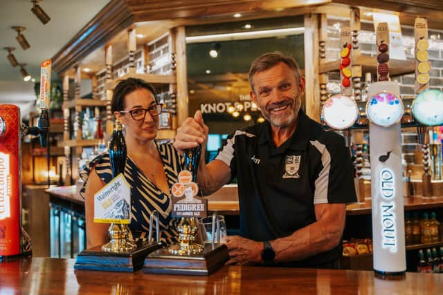 Jim Thomas, Head Coach of Stafford Rangers FC Under 8’s team, pouring the first pint with Clare Edwards, General Manager