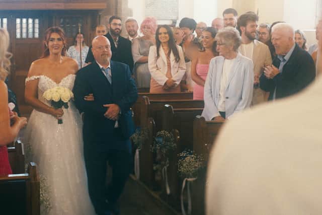 Tori walks down the aisle at Studley Parish Church.