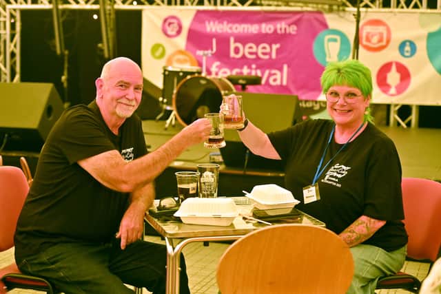 Bob and Jenny Potts both enjoy a drink during their break from volunteering