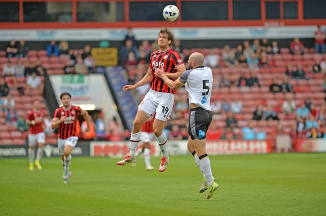 Walsall striker Aaron Pressley battles for the ball against Derby.