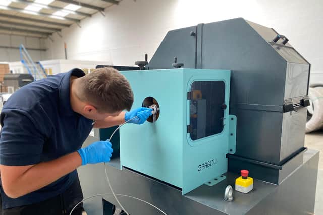 AWI wire technician Daniel Holyhead operating their new specialist linishing machine