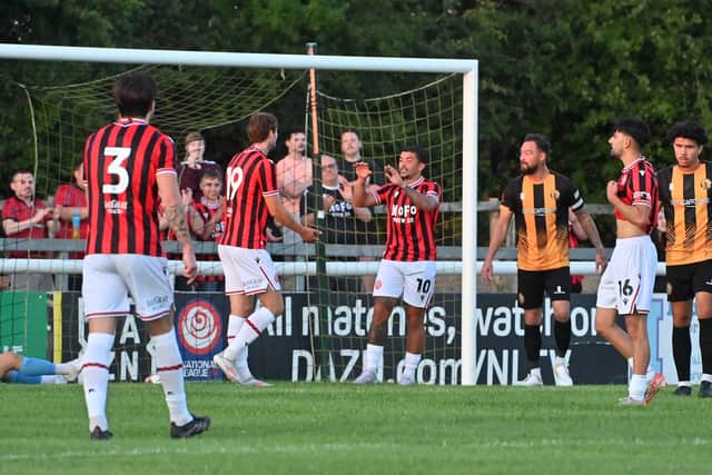 Josh Gordon celebrates Walsall's fourth goal with new strike partner Aaron Pressley.