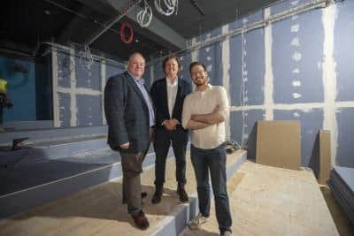Councillor Stephen Simkins, James Jervis of PDJ, and Councillor Chris Burden stand between screens one and two of the new Lockworks Cinema