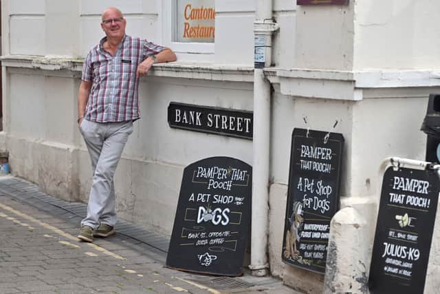 Charlie creates his own signs for the shop