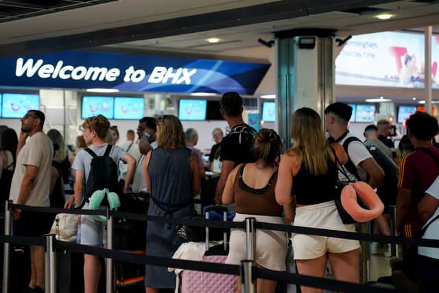 Passengers queue at Birmingham Airport, where they can now keep their drinks in bags