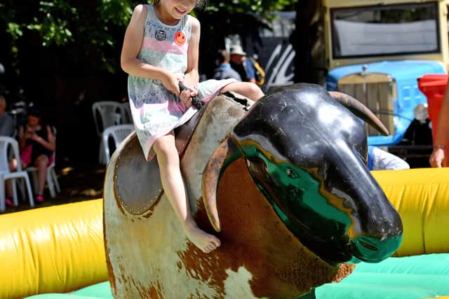 A child riding a mechanical bull at Newport Show 2025.