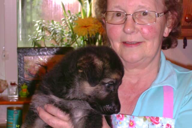 Sandra Boden holding a guide dog puppy born in her home in 2014. Picture: Guide Dogs