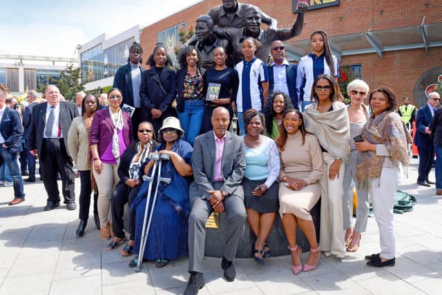 Brendon Batson and family members of the Three Degrees with the statue