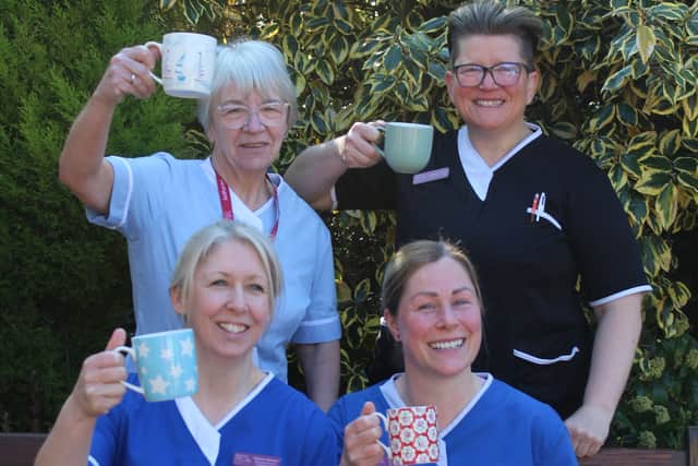 Care staff from the hospice raising a cuppa 
