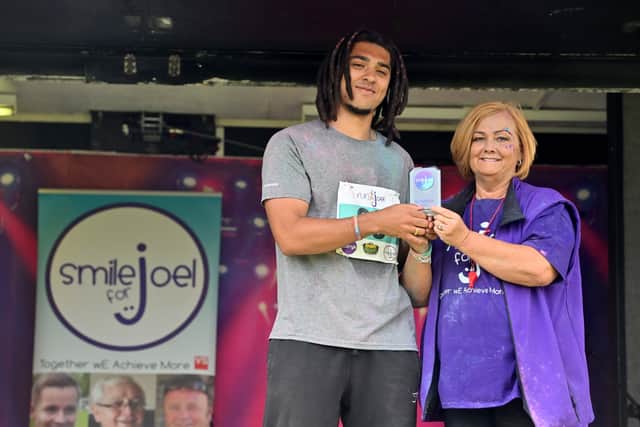 Suzanne Richards presented a trophy to the 5k winner, Solomon Clarke