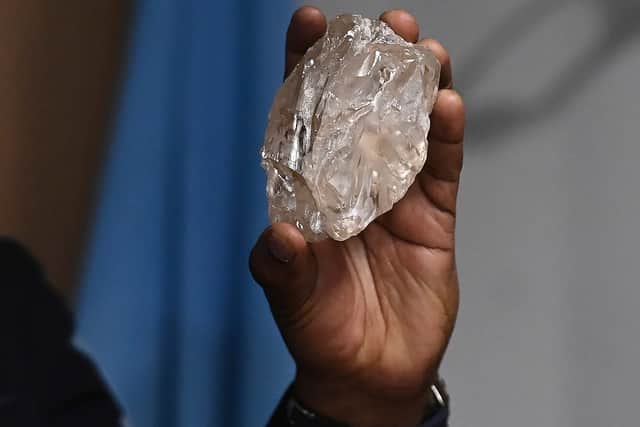 A person holds a 2,492-carat diamond which was found in Botswana