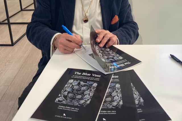 Graham Fisher MBE signing his book about The Blue Vase