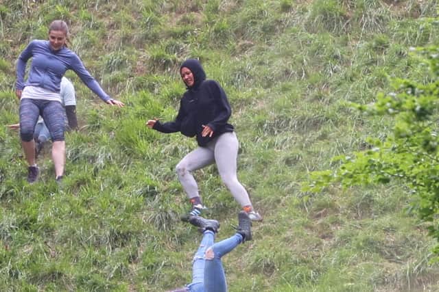 Contestants take part in the women's race of the annual Cheese Rolling Race at Coopers Hill in Brockworth, Gloucestershire this Bank Holiday Monday. May 26 2025.