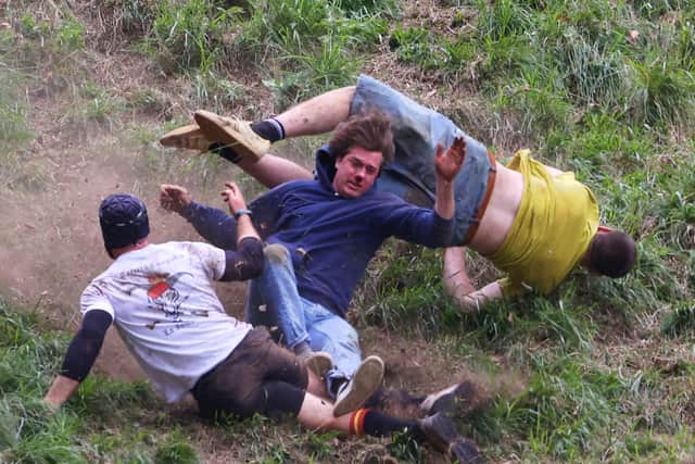 Contestants take part in the annual Cheese Rolling Race at Coopers Hill in Brockworth, Gloucestershire this Bank Holiday Monday. May 26 2025.