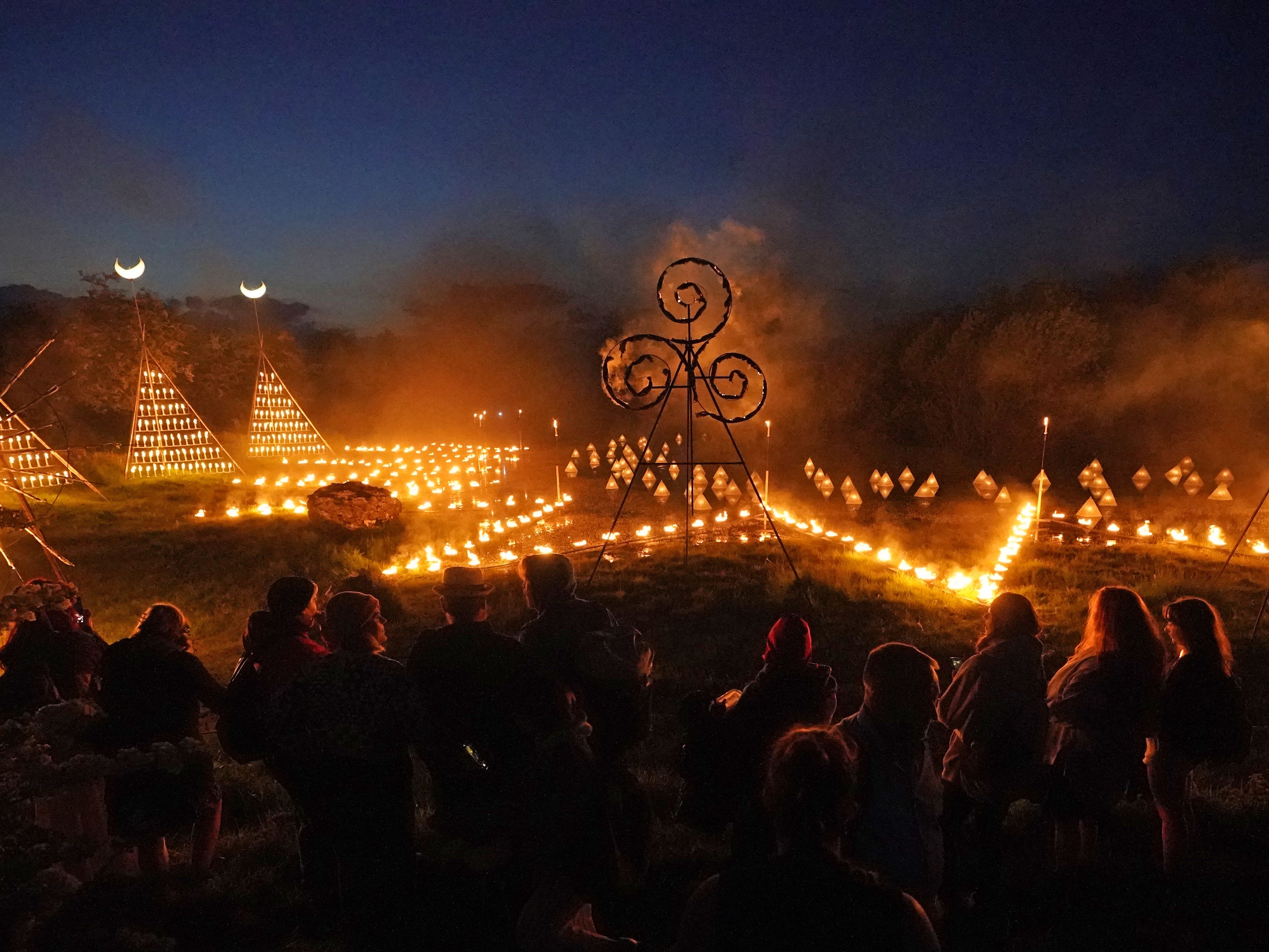 Spectators gather for ancient Celtic fire procession that welcomes summer