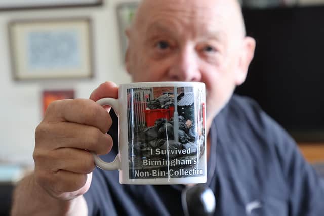 Kevin Beresford with his Birmingham rubbish murchandise calendar, cup and Jig-saw at home in Redditch. 