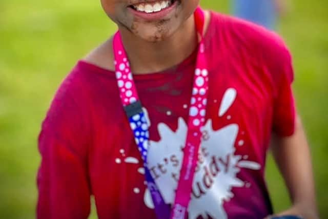 Kurtis after crossing the finishing line last year - his father Elan from Wolverhampton is now cancer free and the pair are fronting the Race for Life campaign this year
