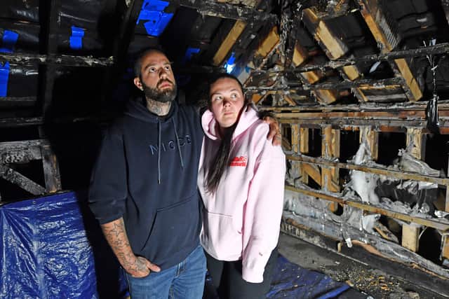 Emma and Jon Logan in the burnt-out loft. Photo: Tim Sturgess