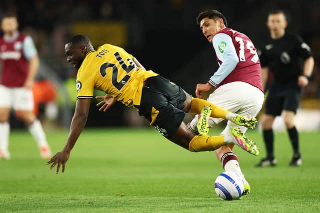 Toti Gomes of Wolverhampton Wanderers falls to the ground as he competes for the ball with Edson Alvarez (Photo by Dan Istitene/Getty Images)