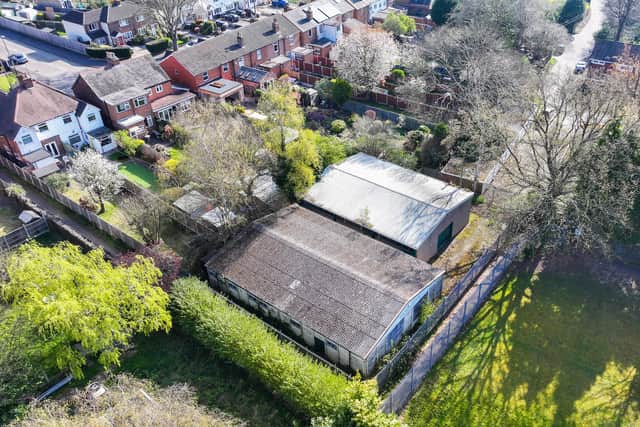 The former Four Oaks Boys Club building behind gardens