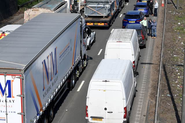 Lorries, cars and vans waited in traffic for the road to reopen