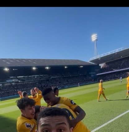 Andre celebrates by taking a Wolves supporters' phone while they record Jorgen Strand Larsen's winner against Ipswich (Picture & video by: Max Harris)
