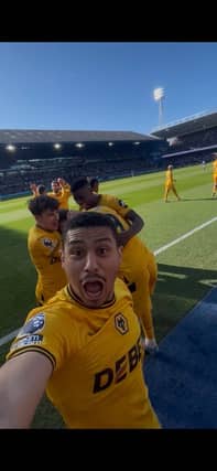 Andre celebrates by taking a Wolves supporters' phone while they record Jorgen Strand Larsen's winner against Ipswich (Picture & video by: Max Harris)