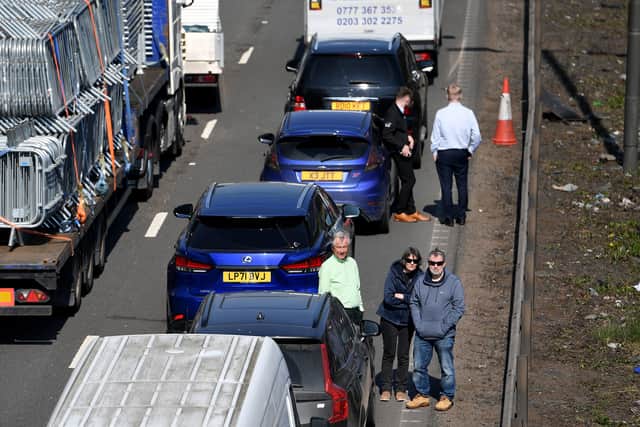Drivers stood by their cars while they waited in the stationary traffic