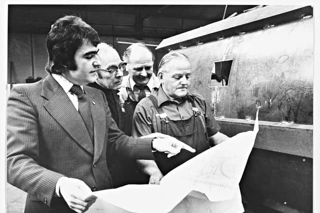 L. Nicklin, sheet metal firm, pictured in 1975. The image shows Barrie Henly going over a working drawing on the shop floor with (second left) Ted Waterfield, Ezra Thornton and Arthur Drew.