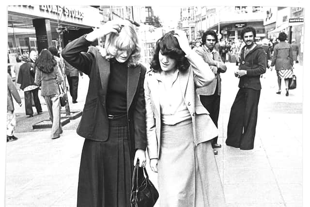 1978 - A mysterious patch of turf had appeared in the street. The photograph shows Helen Jarrams (left) and Anne Collings.