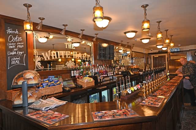 The bar is big and bright and means a lot of people can be served at the same time