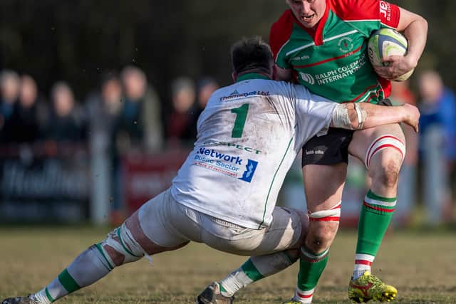 Burntwood's Rob Jones is tackled by Sutton Coldfield's Christopher Lamb (Picture: Jim Wall)