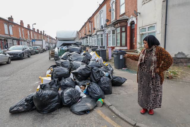 Hawida Osman local resident standing next to rubbish on Percy Road in Sparkhill Birmingham ahead of Tuesday's 'all out strike'.
