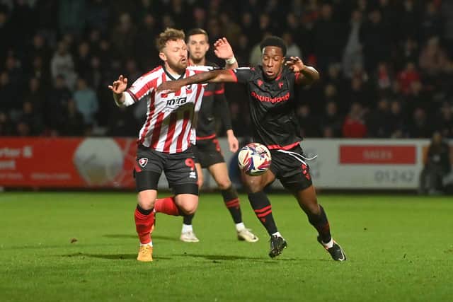 Walsall wing-back Liam Gordon tussles for the ball.