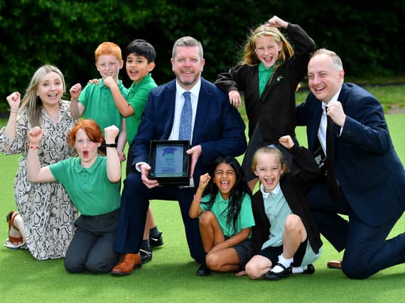 Headteacher Simon Arnold (centre) with fellow staff members senior leader Faye Billingsley and Deputy Headteacher Paul Lane celebrate with pupils after Oak Meadow Primary School was awarded Primary School of the Year 2023